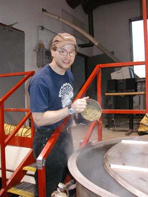 [View of Anthony adding hops to boil]