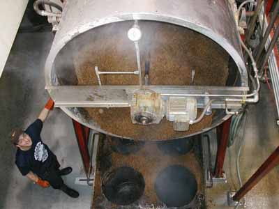 [View of Anthony cleaning mash tun]